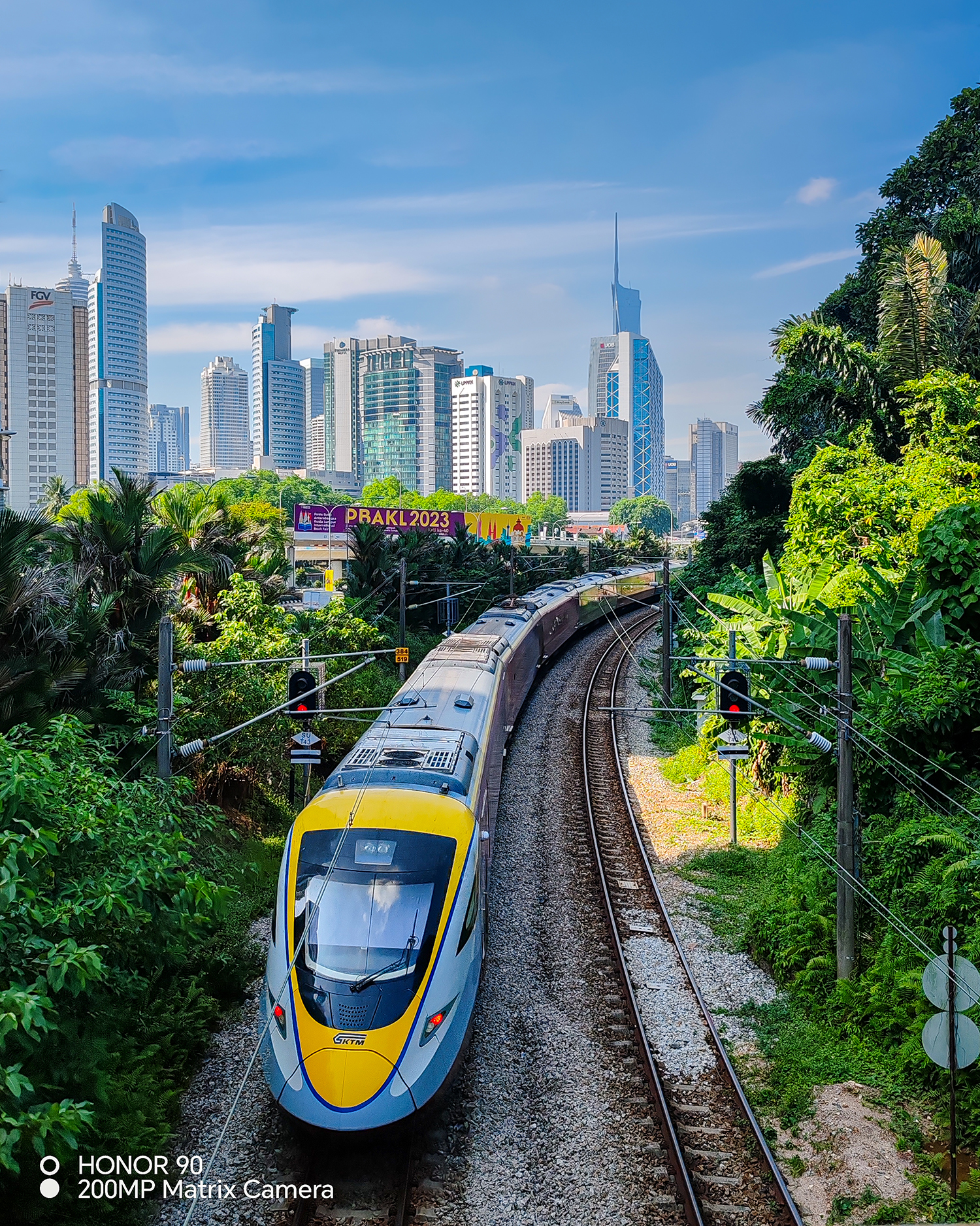 The train zooms swiftly out of the metropolitan city.